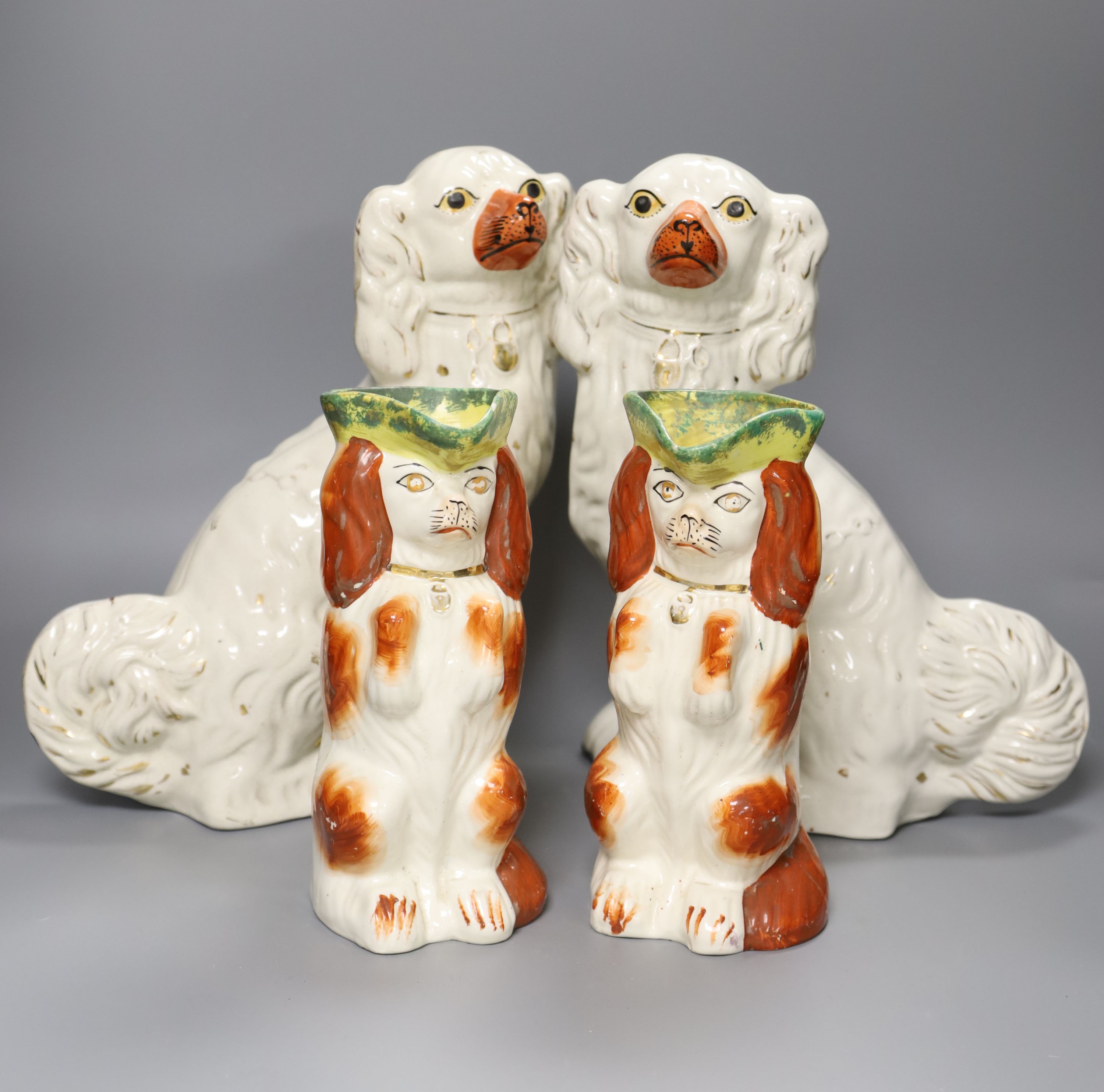 Two pairs of 19th century Staffordshire King Charles Spaniels, height 31cm